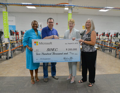 Microsoft Corp representative presents a check to SVHEC staff 