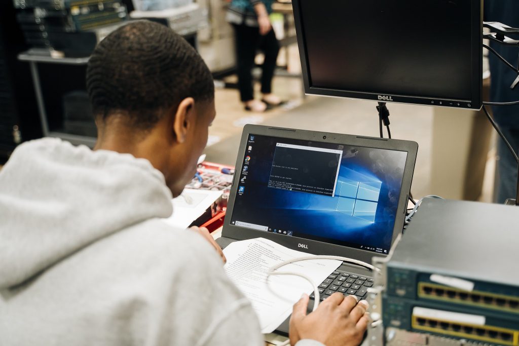 Image of Career Tech Academy Student looking at DOS prompt on laptop screen.