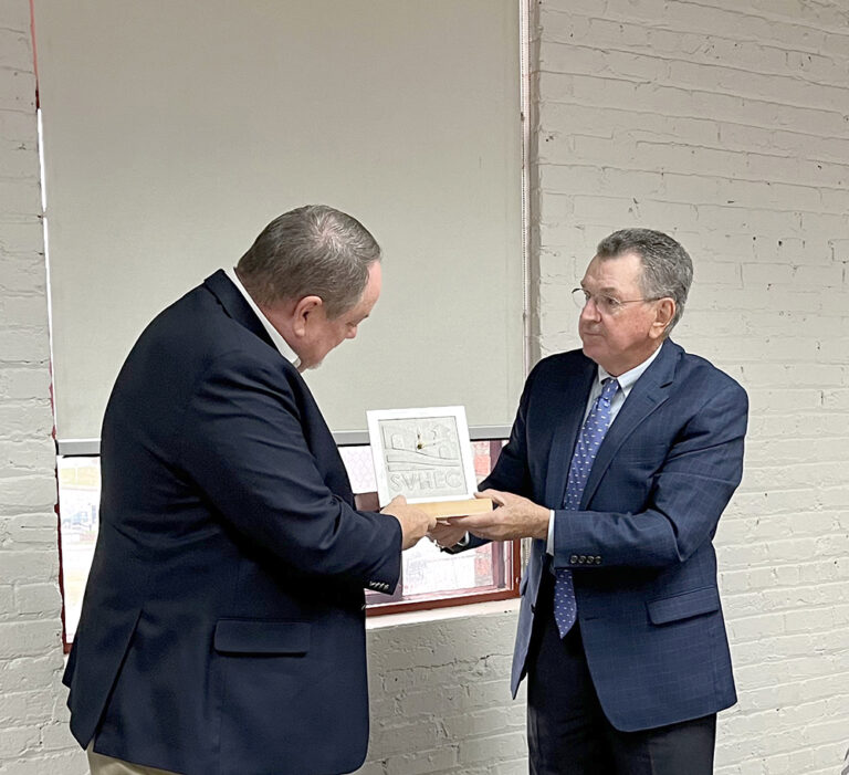 Board of Trustees Chairman, Dennis Witt (right) presents outgoing board member John Lee with a custom clock designed and produced by ProductWorks@SVHEC.